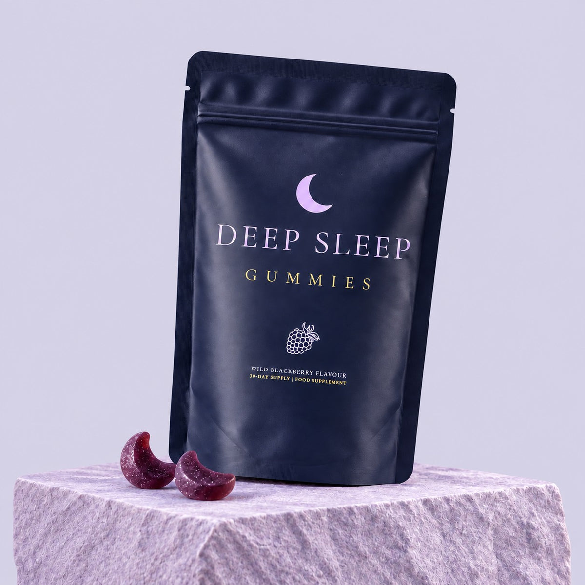 Deep Sleep Gummies on a stone plinth at dusk