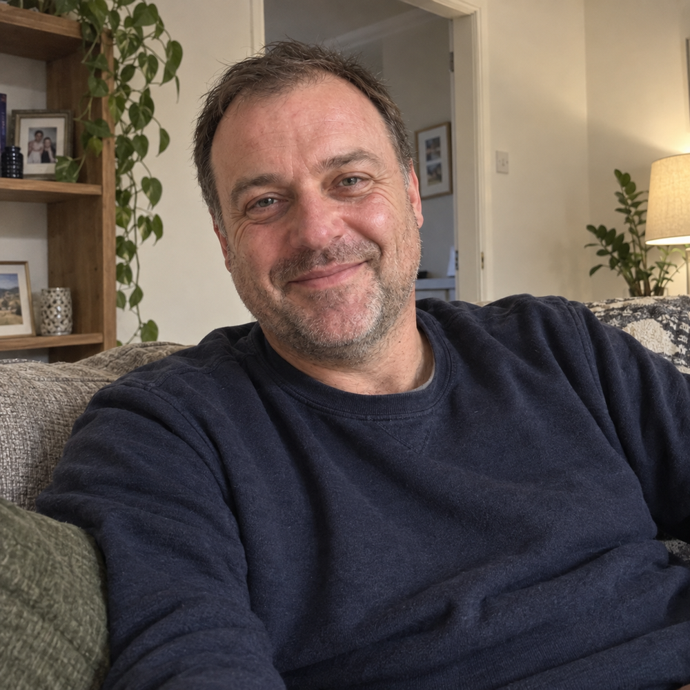 Smiling man sitting comfortably at home