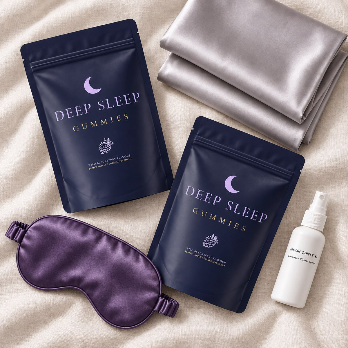 Two Deep Sleep Gummies pouches, two satin pillowcases, a purple mask and a white pillow spray